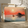 Framed canvas print of a sailboat on calm waters with sunrise and warm hues