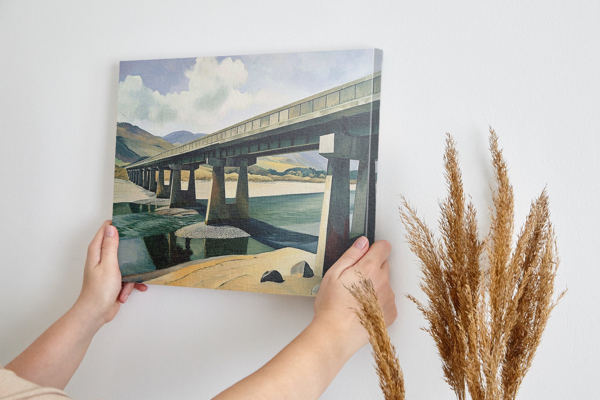 Framed canvas print of a serene countryside bridge over a river with mountain backdrop