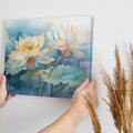 Framed canvas print of tranquil watercolor lotus flowers with pastel hues on a serene blue background