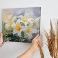 Framed canvas print of impressionist style lilies in vibrant cream and yellow hues