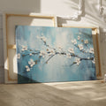 Framed canvas print of serene cherry blossoms with impasto texture on blue background