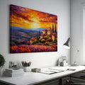 Framed canvas print of an Impressionist Tuscan landscape with a vibrant sunset sky, overlooking lavender fields and rustic houses.