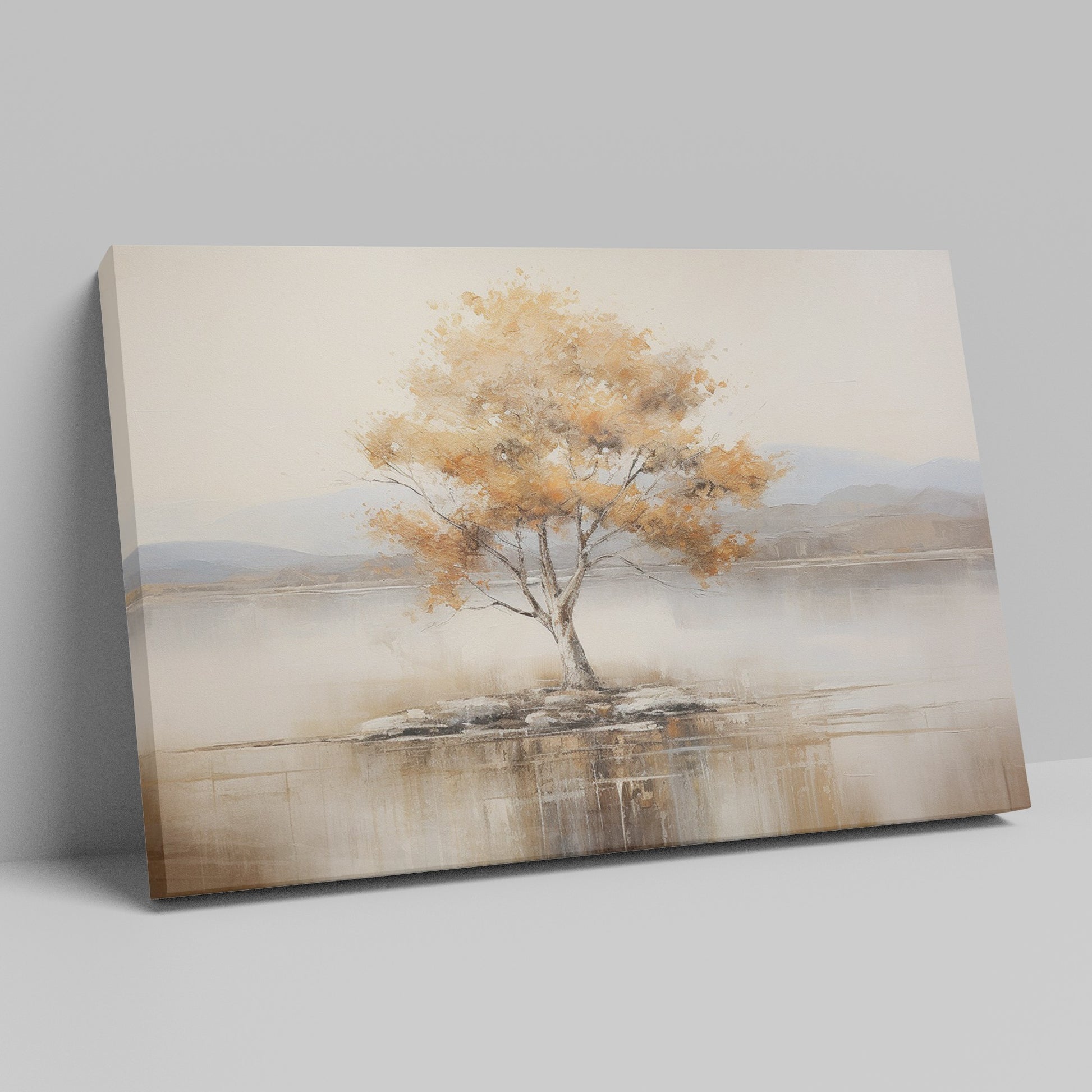 Framed canvas print of a solitary tree with autumn leaves reflected on a calm lake with warm beige, gold, and white tones