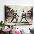 Framed canvas print depicting two karate practitioners in a traditional dojo with red accents