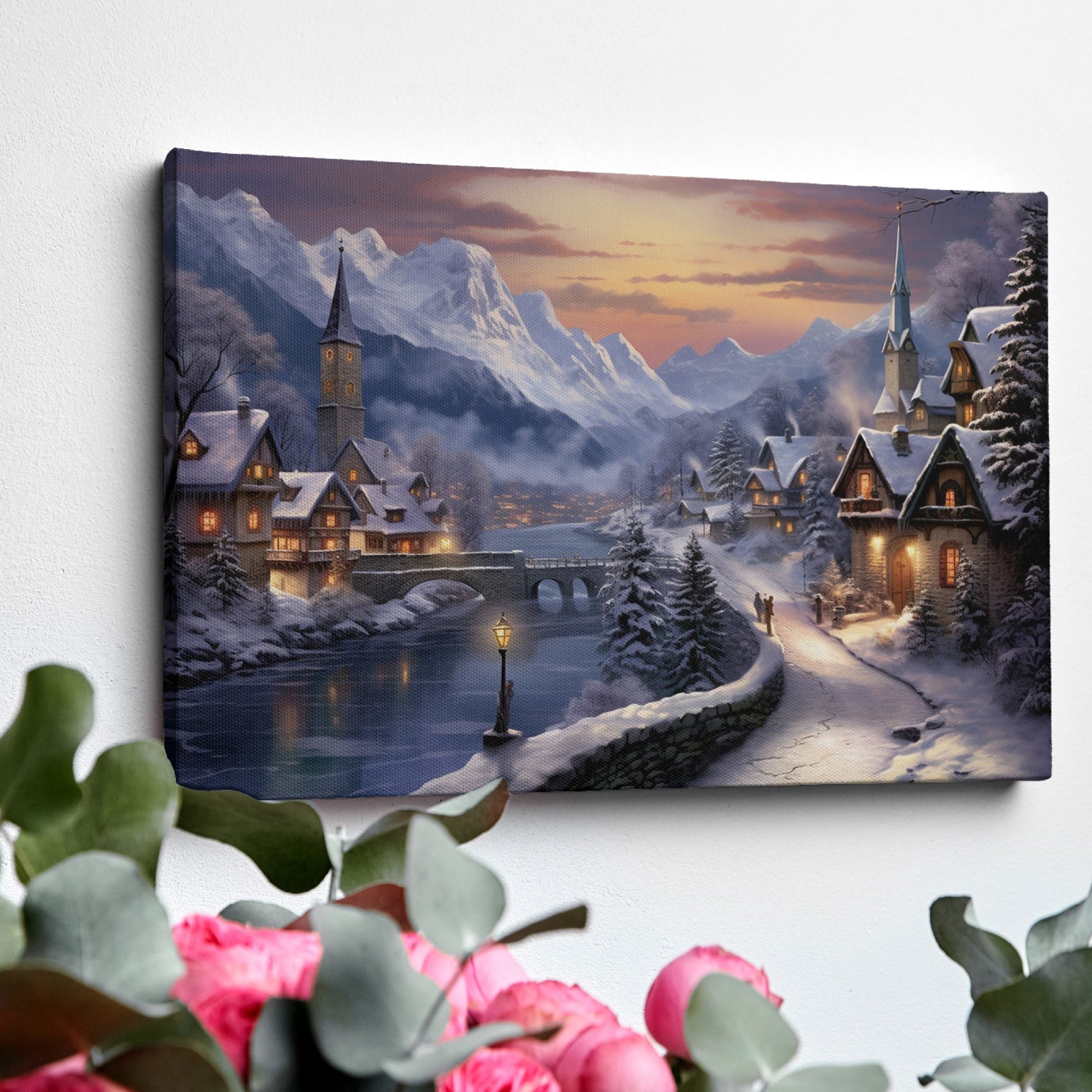 Framed canvas print of a snowy Alpine village at twilight with warm glowing cottages and snow-capped mountains