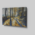 Framed canvas print of a sunlit forest pathway with golden tones and tree silhouettes