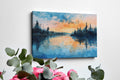 Framed canvas print of a watercolour painting with sunset over a lake and forest silhouette