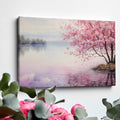 Framed canvas print of a serene cherry blossom tree by a quiet lake with pink and purple reflections