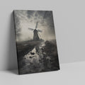 Framed canvas print of a misty Dutch windmill landscape with dramatic sky and reflection in puddle