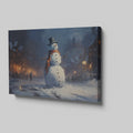 Framed canvas print of a snowman in a winter evening townscape with warm street lights and snowfall