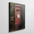 Framed canvas print of a classic British red postbox surrounded by greenery