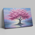 Framed canvas print of a blossoming cherry tree by the water with sunset reflection