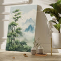 Framed canvas print of a misty bamboo forest with mountain peaks in the background