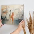 Framed canvas print of ethereal stylised women in a mystical, abstract landscape with orange and ivory tones