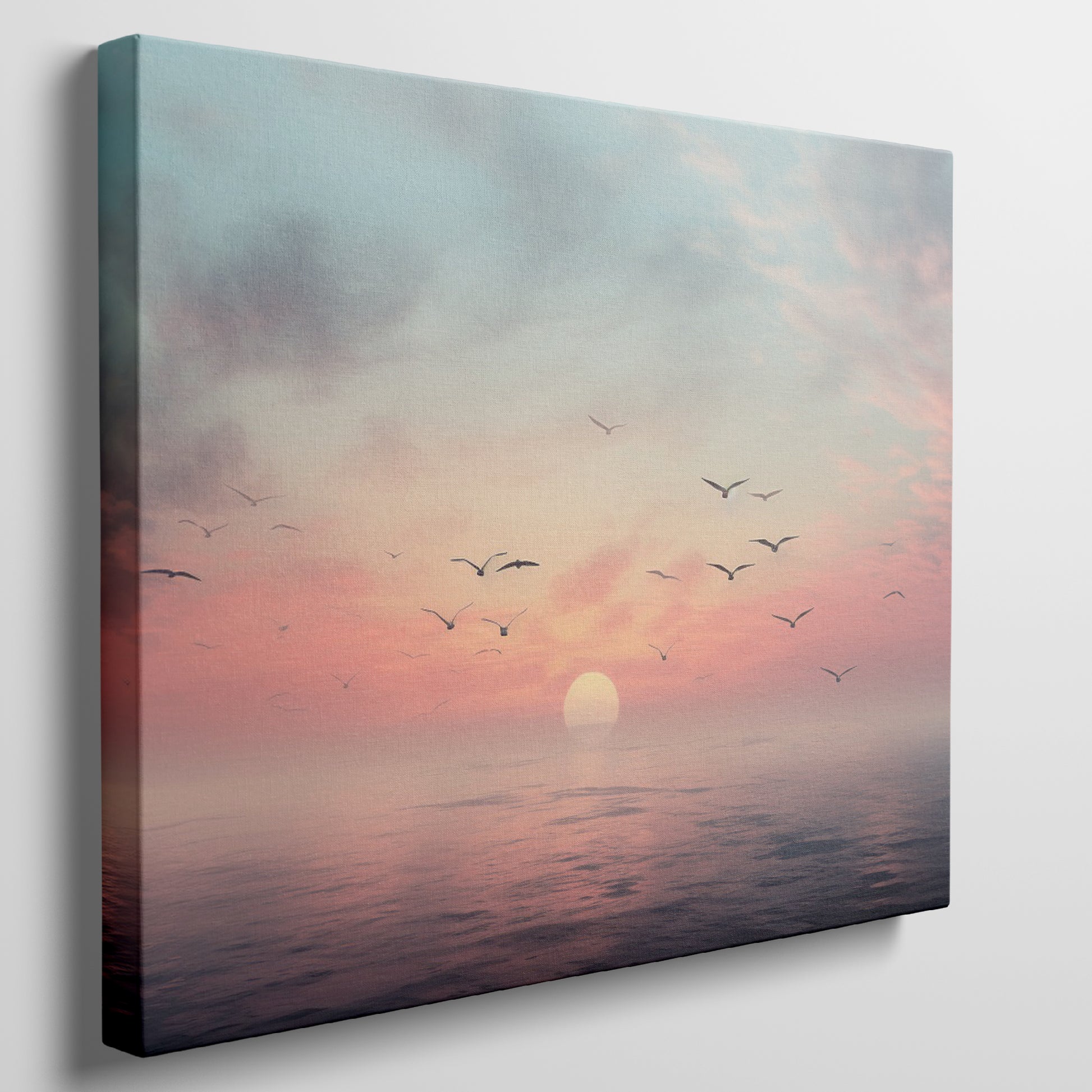 Framed canvas print of a tranquil seascape at sunset with birds and pastel skies