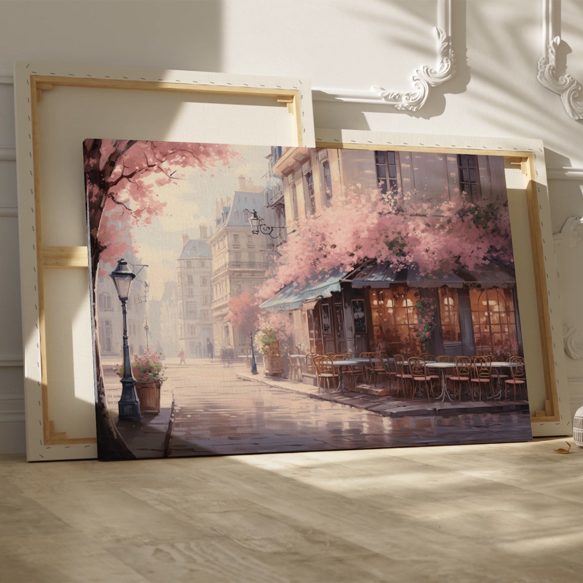 Framed canvas print of a Parisian cafe on a cobblestone street with cherry blossoms in full bloom