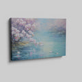 Framed canvas print of a serene landscape with cherry blossoms over tranquil waters