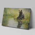 Framed canvas print of a bear sitting by a pond with floral surroundings