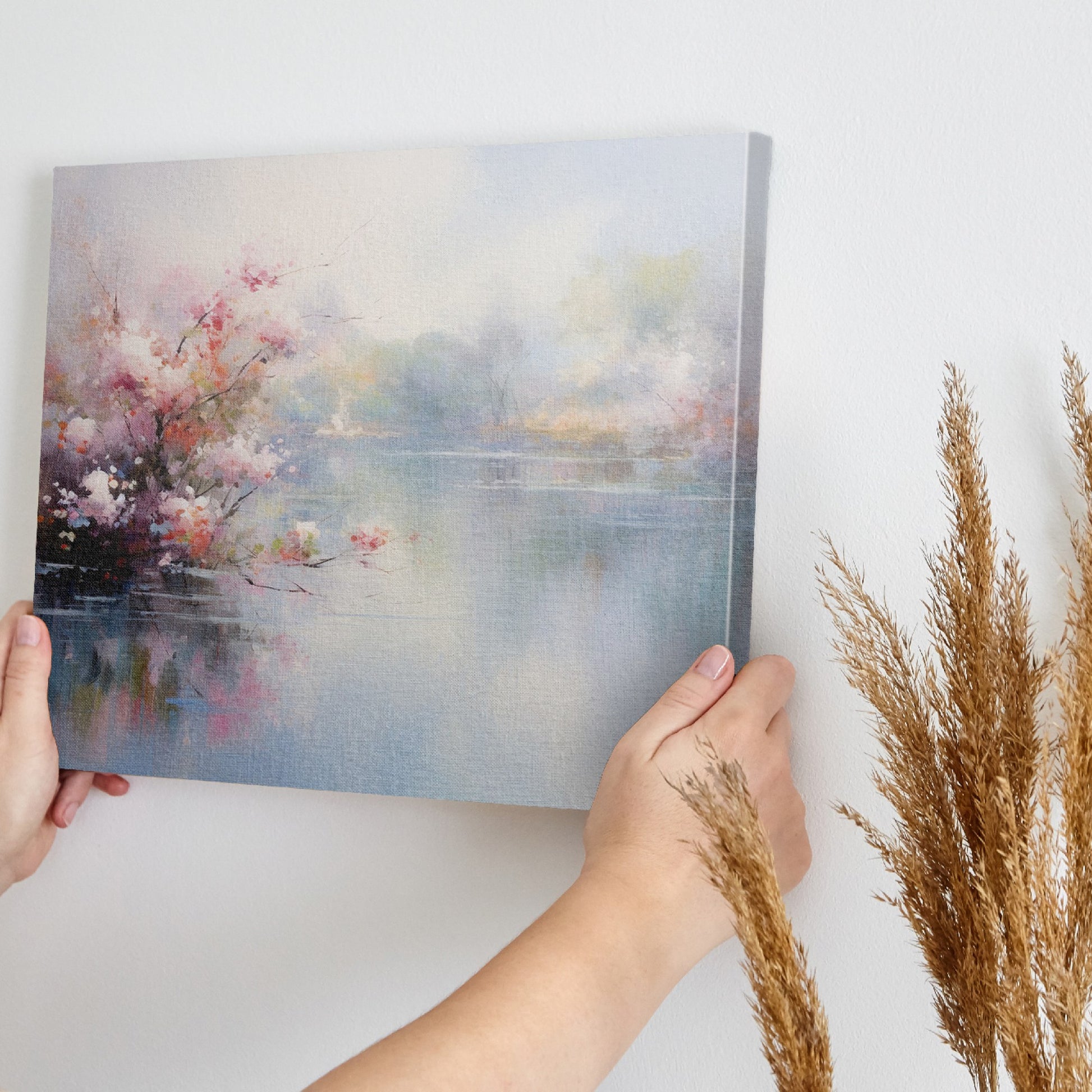 Framed canvas print depicting impressionist art of blossoming trees by a misty lake with soft pastel colours