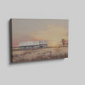 Framed canvas print of a rustic barn surrounded by tranquil fields at sunset, with warm golden and earthy tones.