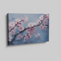 Framed canvas print of cherry blossoms with rain droplets on blue background