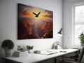 Framed canvas print of a majestic eagle flying over a grand canyon at sunrise with radiant warm colours