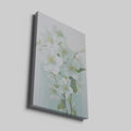 Framed canvas print of delicate white blossoms with a pastel background