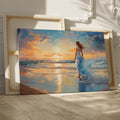 Framed canvas print of a woman in an elegant dress at sunset on a beach, with vibrant reflection in water