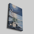 Blue and white moonlit seascape painting with flowers, rocks, and water