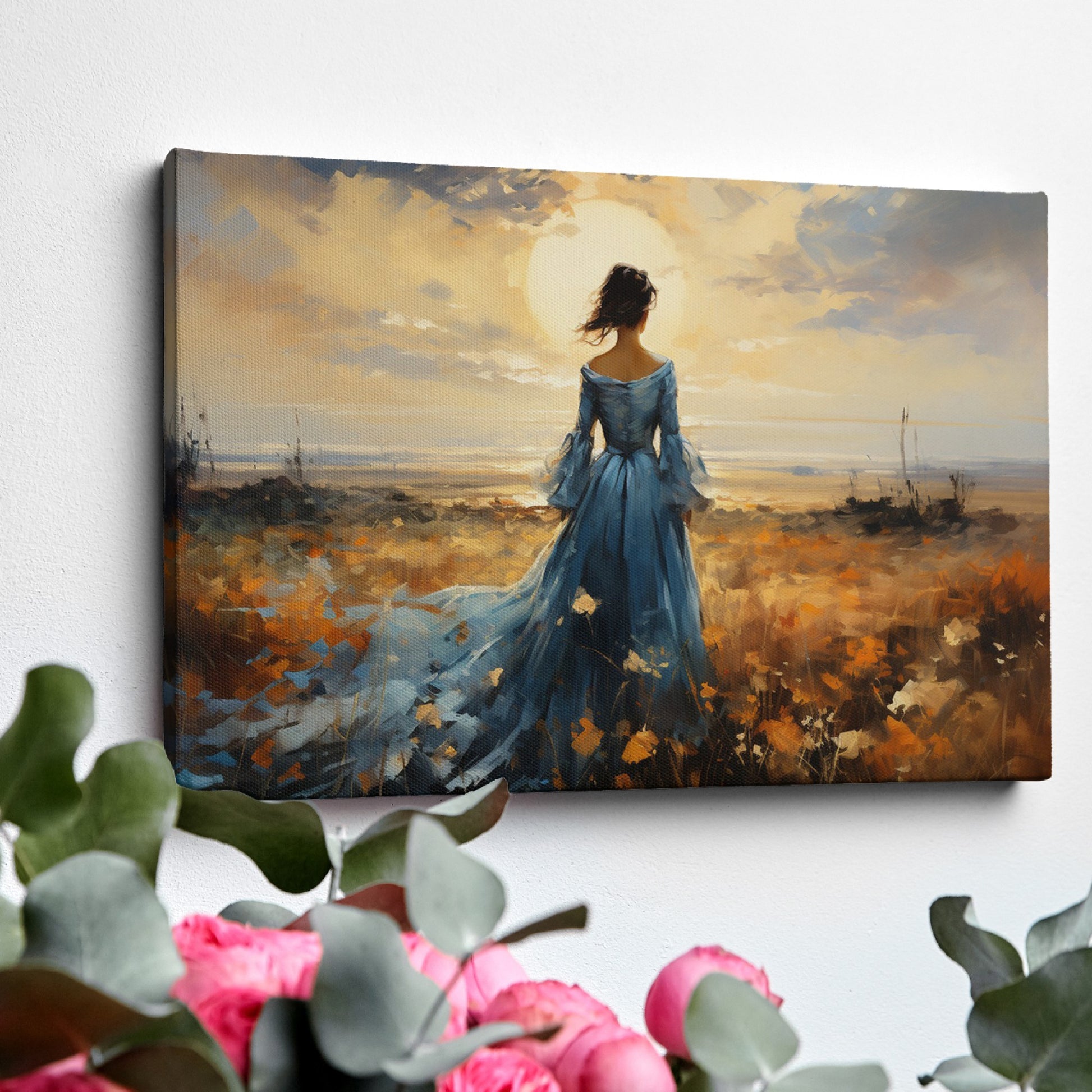 Framed canvas print of an elegant lady in a blue dress against a rural sunset backdrop with warm hues and a dramatic skyline