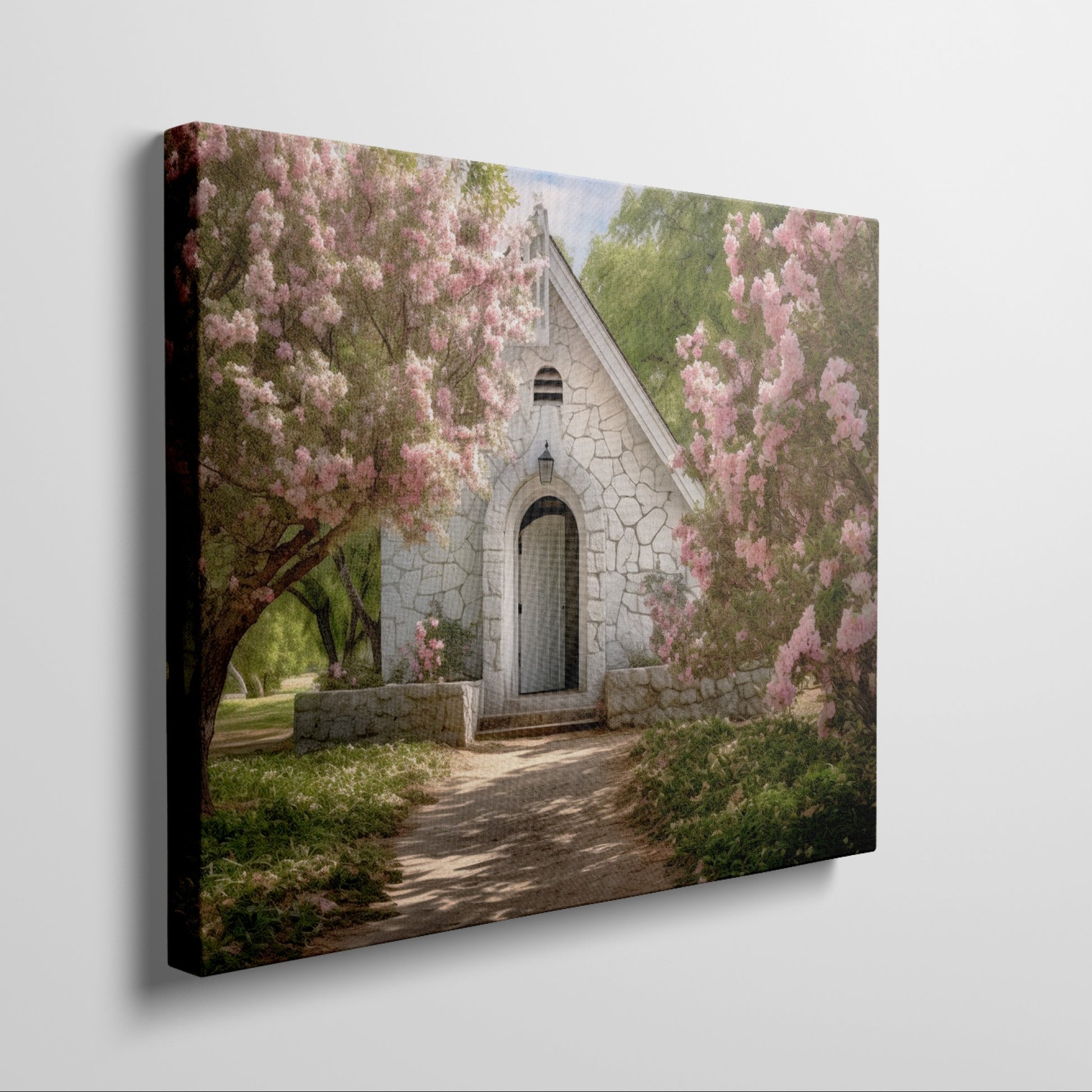 Framed canvas print of a chapel surrounded by lush pink blossom trees