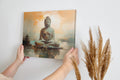 Framed canvas print of serene Buddha in meditation with warm earth tones and tranquil setting