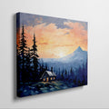 Framed canvas print of a mountain sunrise with a rustic cabin amongst pine trees