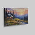 Framed canvas print of a rustic cabin at sunset with a mountainous backdrop