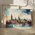 Framed canvas print of abstract watercolour cityscape with vibrant blue, orange and black tones