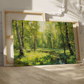 Framed canvas print of a lush forest scene with birch trees and a stream with sunlight filtering through green leaves