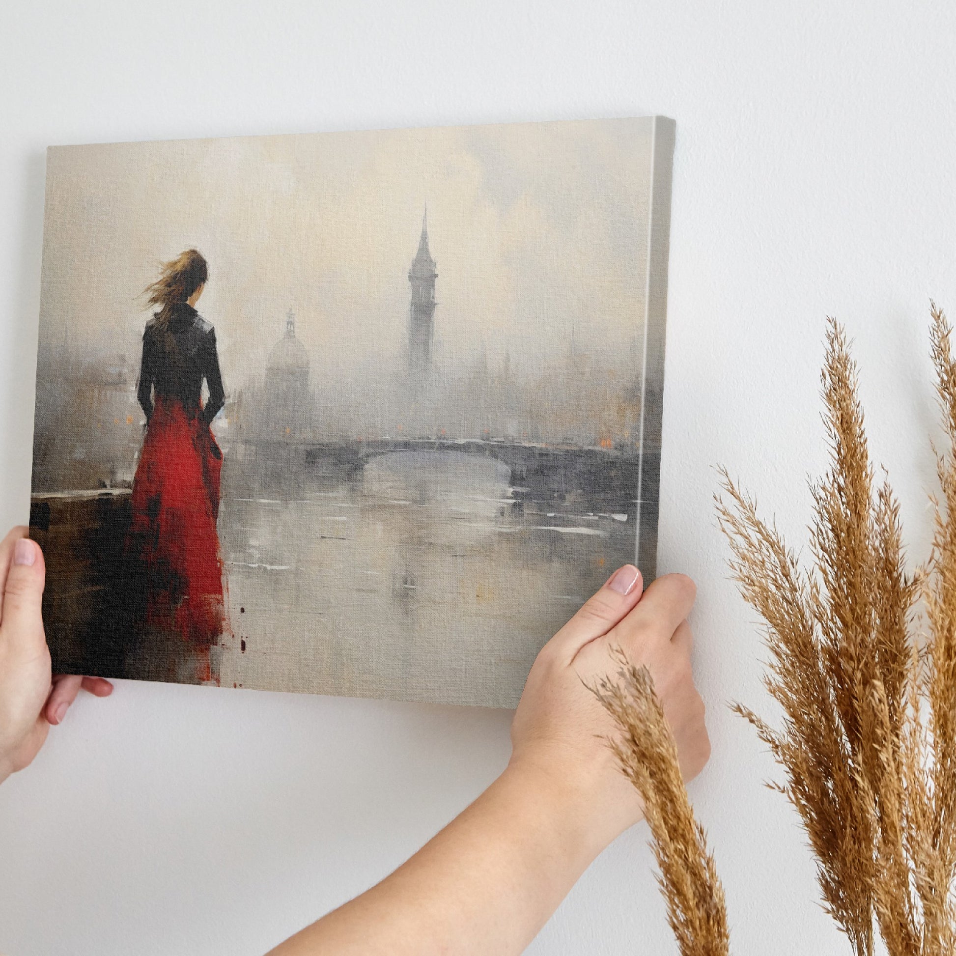 Framed canvas print of an elegant woman overlooking a misty cityscape with a red dress as a focal point