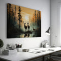 Framed canvas print of deer silhouetted against a forest sunset with reflections on water