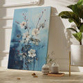 Framed canvas print of ethereal white blossoms with red berries against a textured blue abstract background