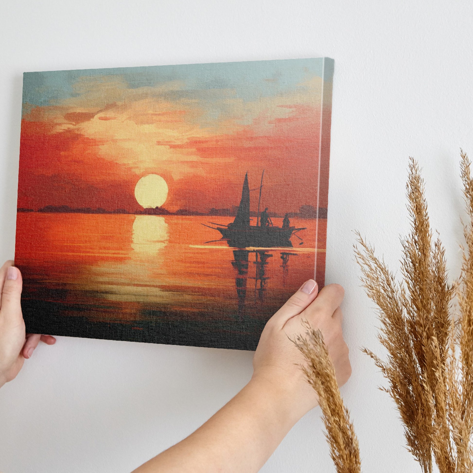 Framed canvas print of a sailboat silhouetted against a sunset with warm red and orange tones