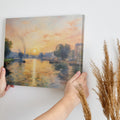 Framed canvas print of an Impressionist-style river scene with a sunset, reflective water and boats