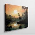 Framed canvas print of a majestic stag against a forest lake at sunrise with orange skies