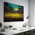 Framed canvas print of an impressionist painting capturing a football match at sunset with a cheering crowd