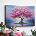 Framed canvas print of a blossoming cherry tree by the water with sunset reflection