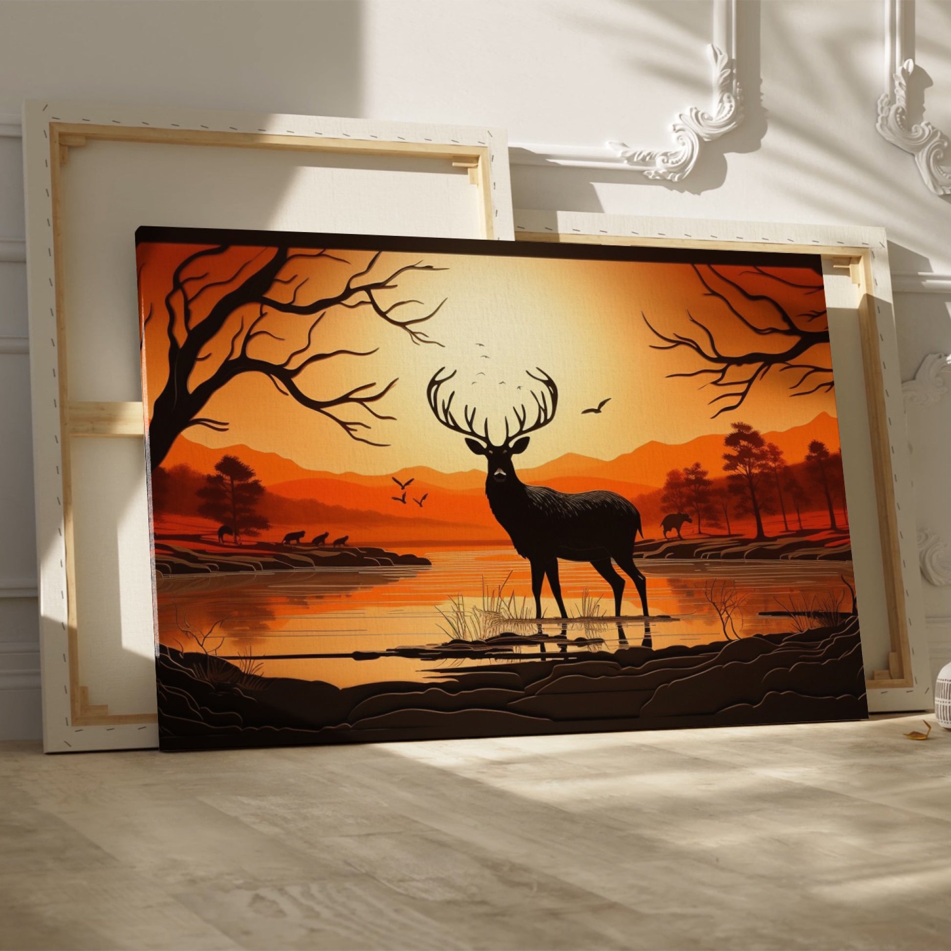 Printed canvas art of a black deer silhouette against an orange sunset with trees and mountains