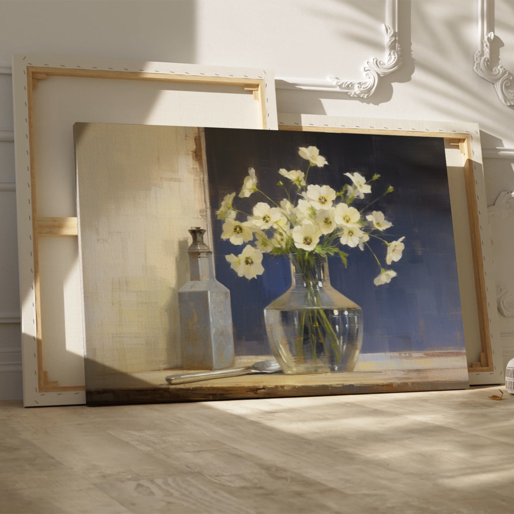 Framed canvas print of white flowers in glass vase with vintage bottle on a neutral background