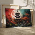 Framed canvas print of an oriental pagoda in crimson and teal colours with moonlit scenery