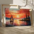 Framed canvas print of a sailboat sailing at sunset with vibrant sky and reflective water