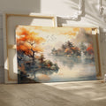 Framed canvas print of an Asian-inspired scene featuring traditional Chinese pagodas amid autumnal trees by a misty lake with a waterfall