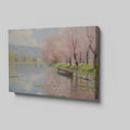 Framed canvas print of a tranquil river landscape featuring blooming cherry blossoms and a boat, in Impressionist style